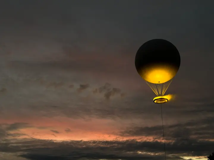 Illuminated balloon in the evening sky